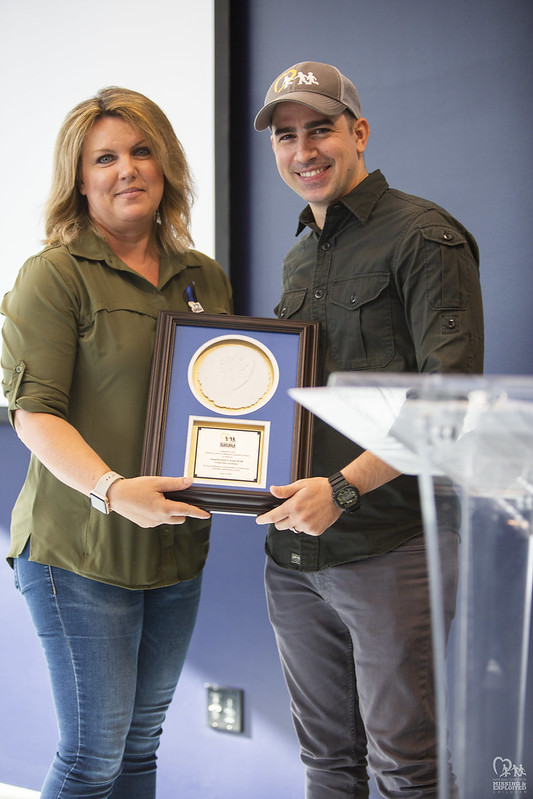 Sergeant Karen Kozak accepts her award from Callahan Walsh.