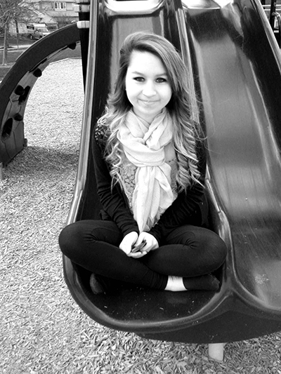 Amanda sitting on a slide