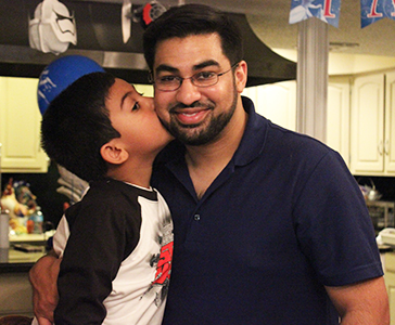 boy kisses dad on cheek