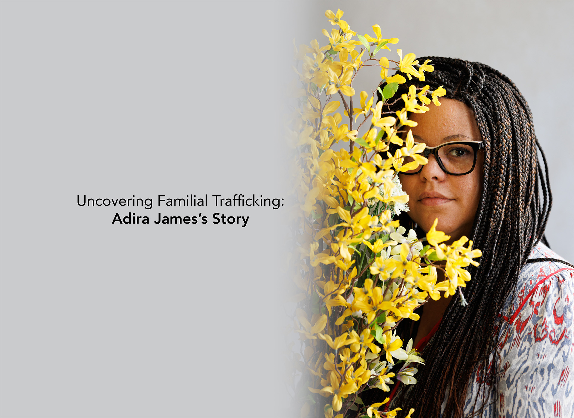 Adira partially standing behind a yellow flower