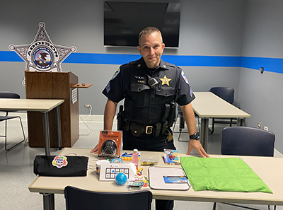 Sgt. Stefan Bjes standing with sensory kits 