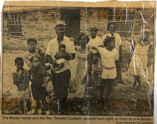 sepia toned newspaper clipping of Brown family, including the mother, father, and kids