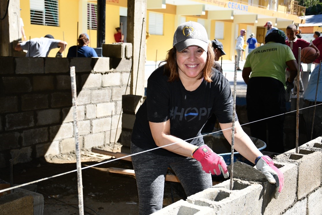 Stacy LaRossa applying cement to bricks