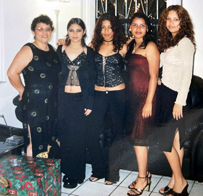 five latina women stand together and smile before a formal event