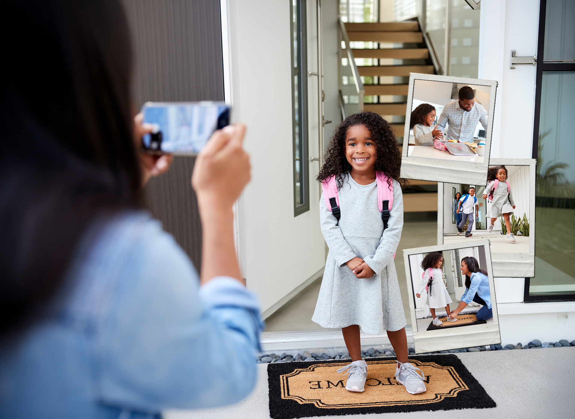 elementary aged girl stands on front porch smiling while mom takes picture