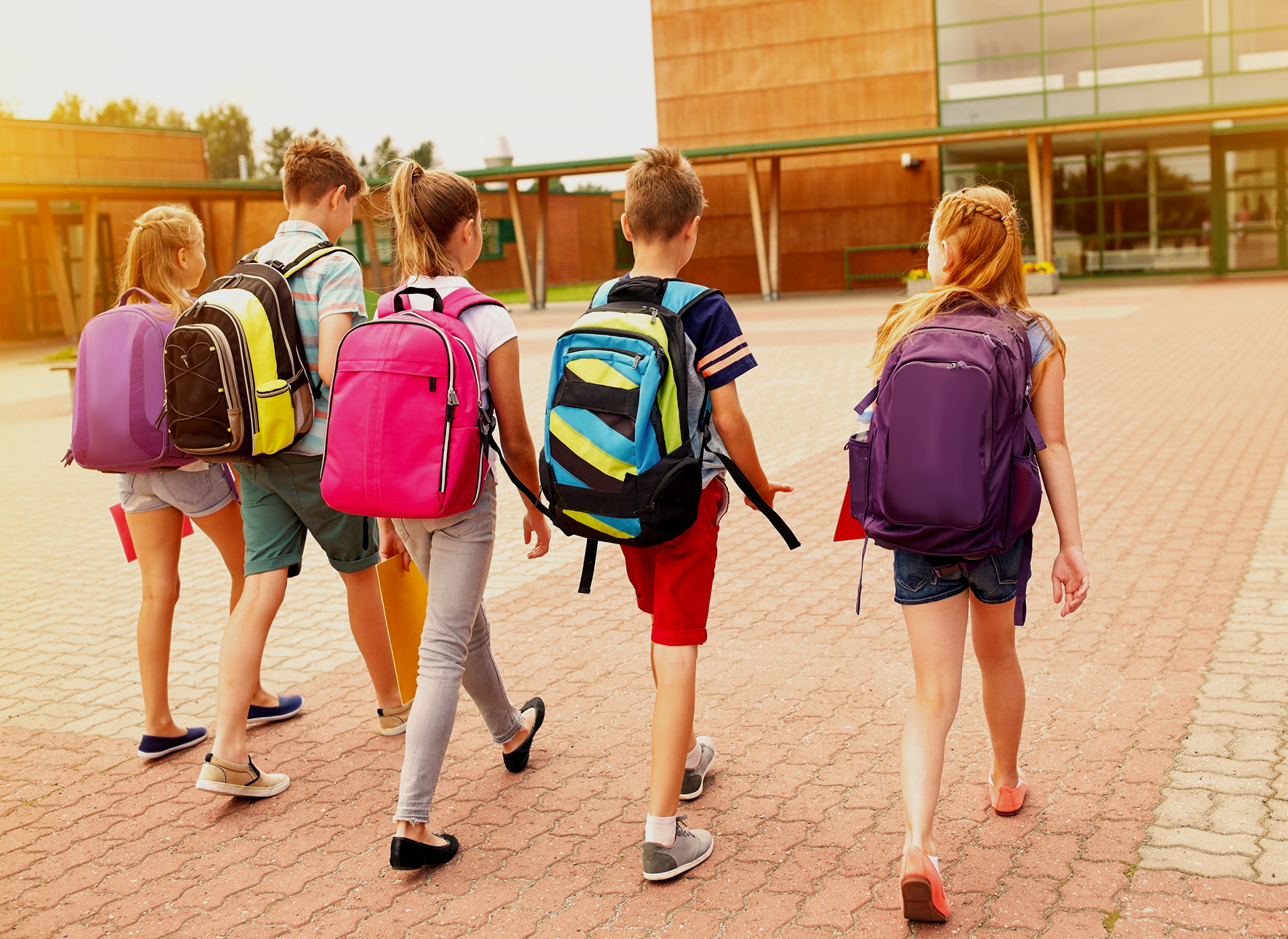 five children walk into school, we see their backpacks