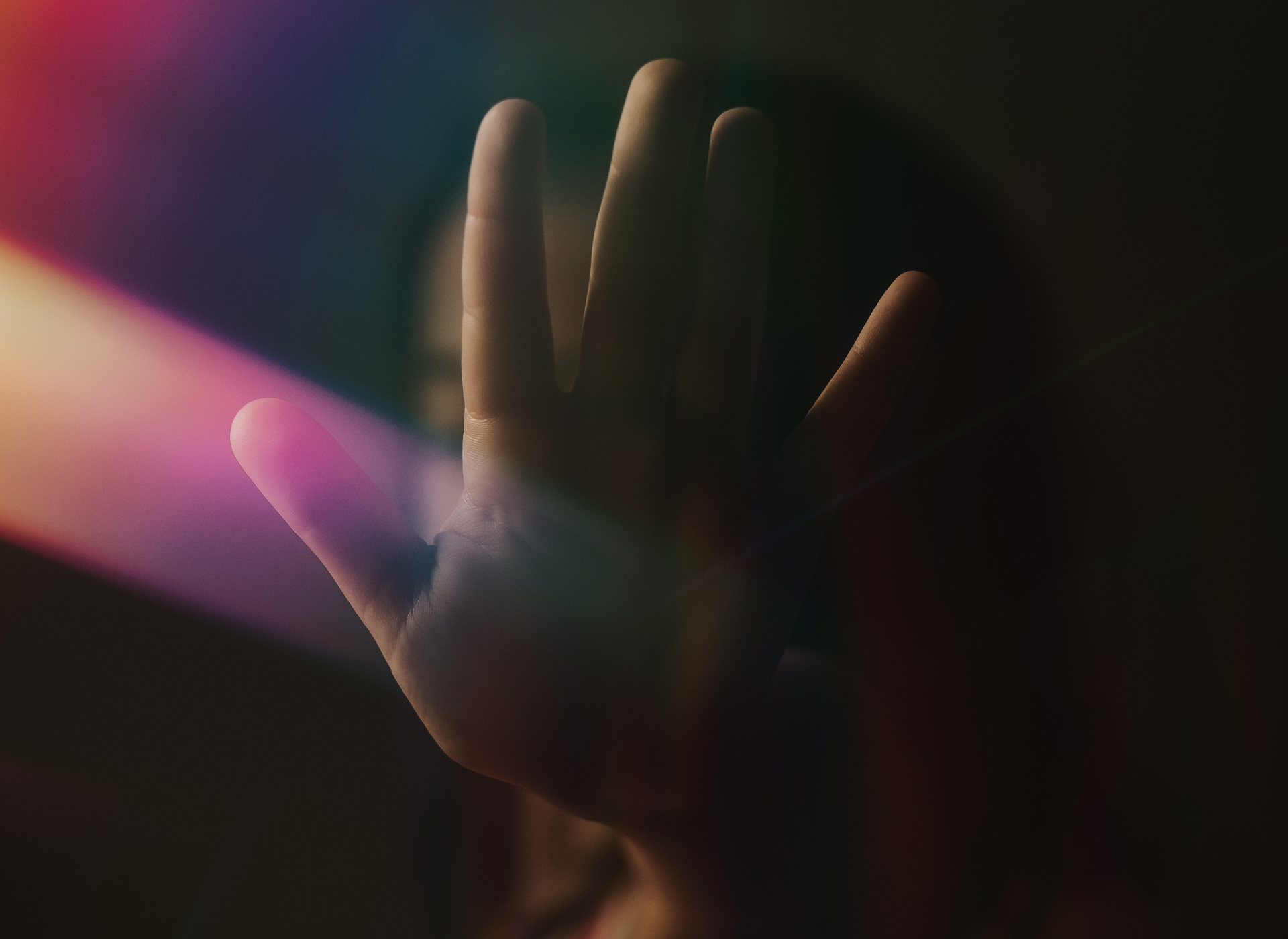 silhouette of child's hand in a stop sign