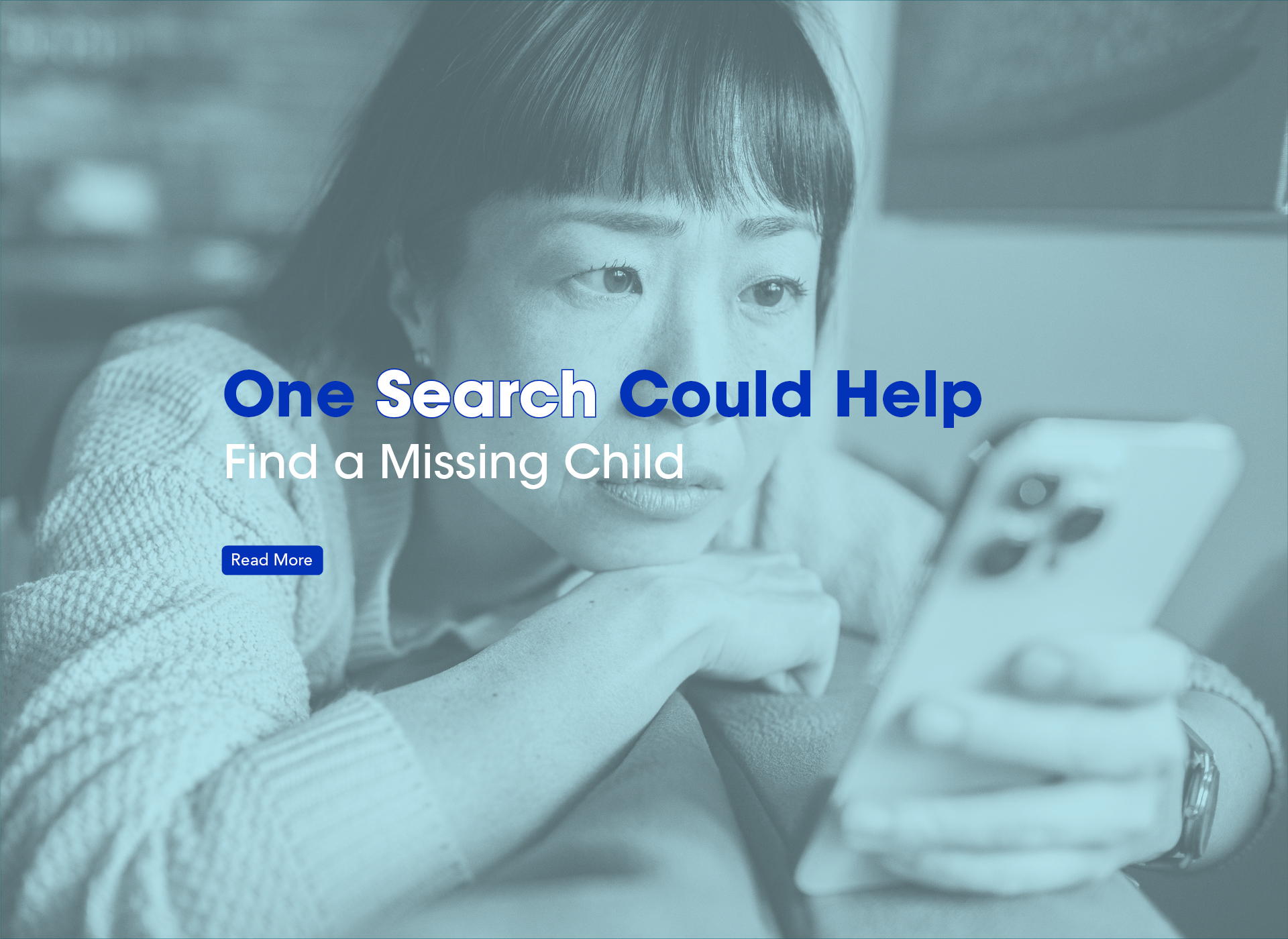 teen girl looks at phone; blue tint to image