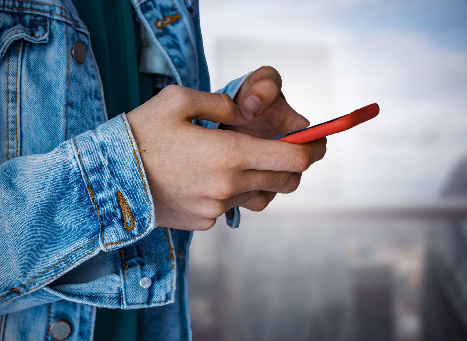 close up of teenage boy using smart phone