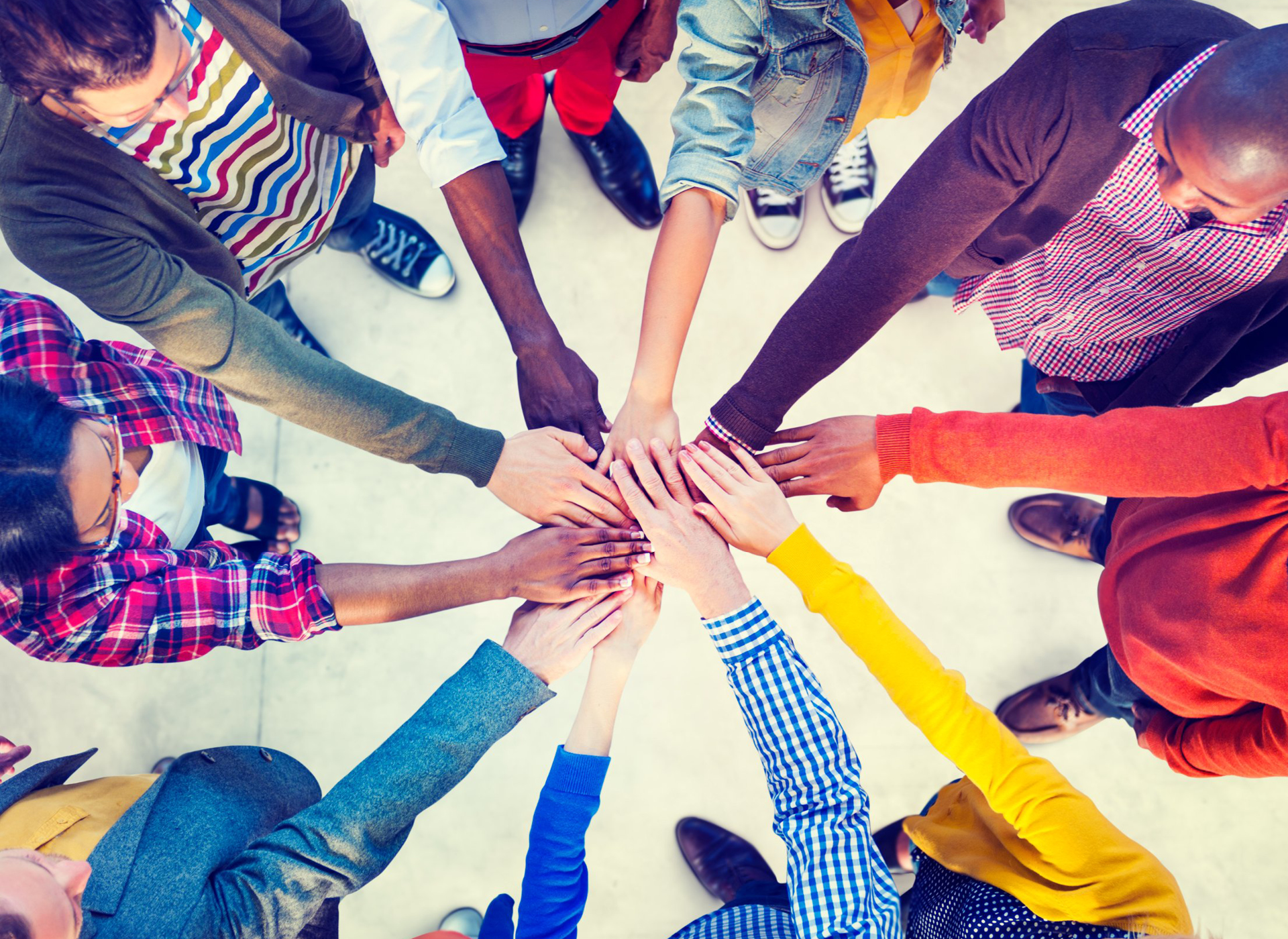 Multi-racial group of people standing in a circle